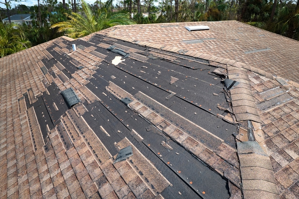 Damaged asphalt shingles roof in hot climate